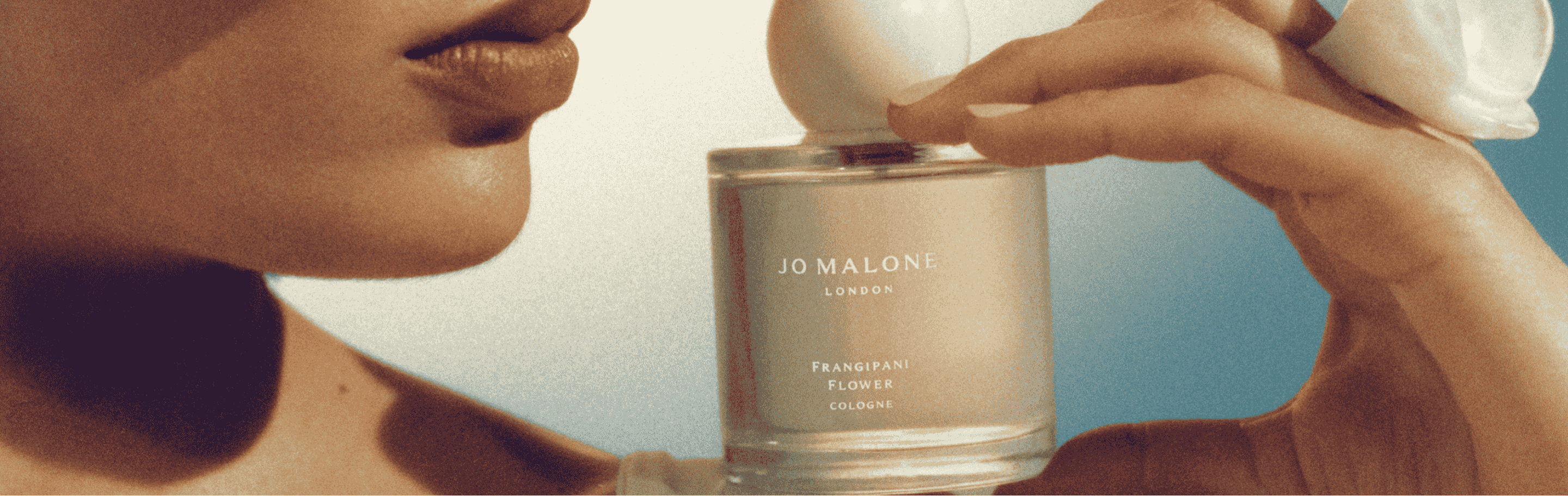 Jo Malone London Orange Bitters Collection Candle Cologne with gold lids on glittering gold plinths